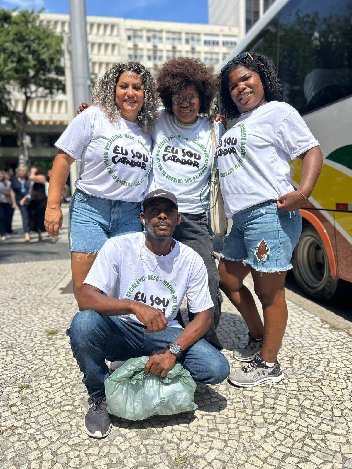 Catadoras e catador com camisetas Eu Sou Catador na rua