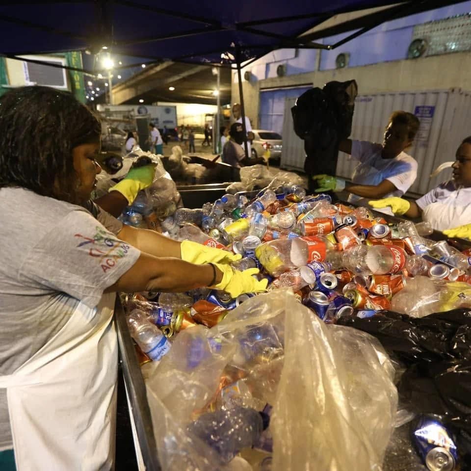 Catadoras fazem a triagem de latas e garrafas